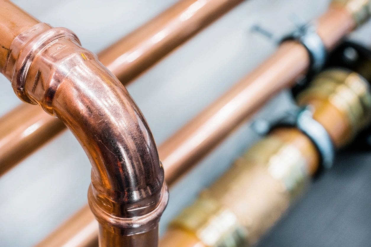A close up of copper pipes and valves